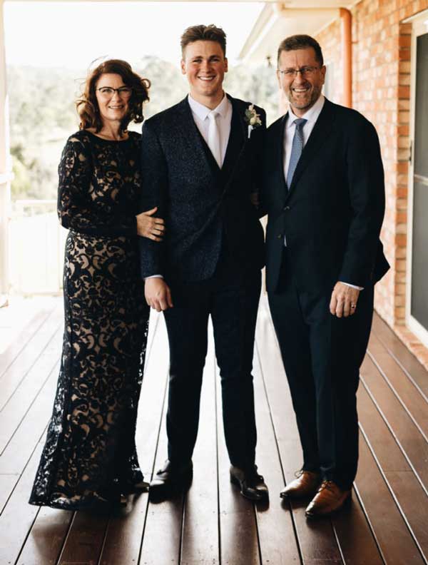 Proud mum and dad with groom on his wedding day